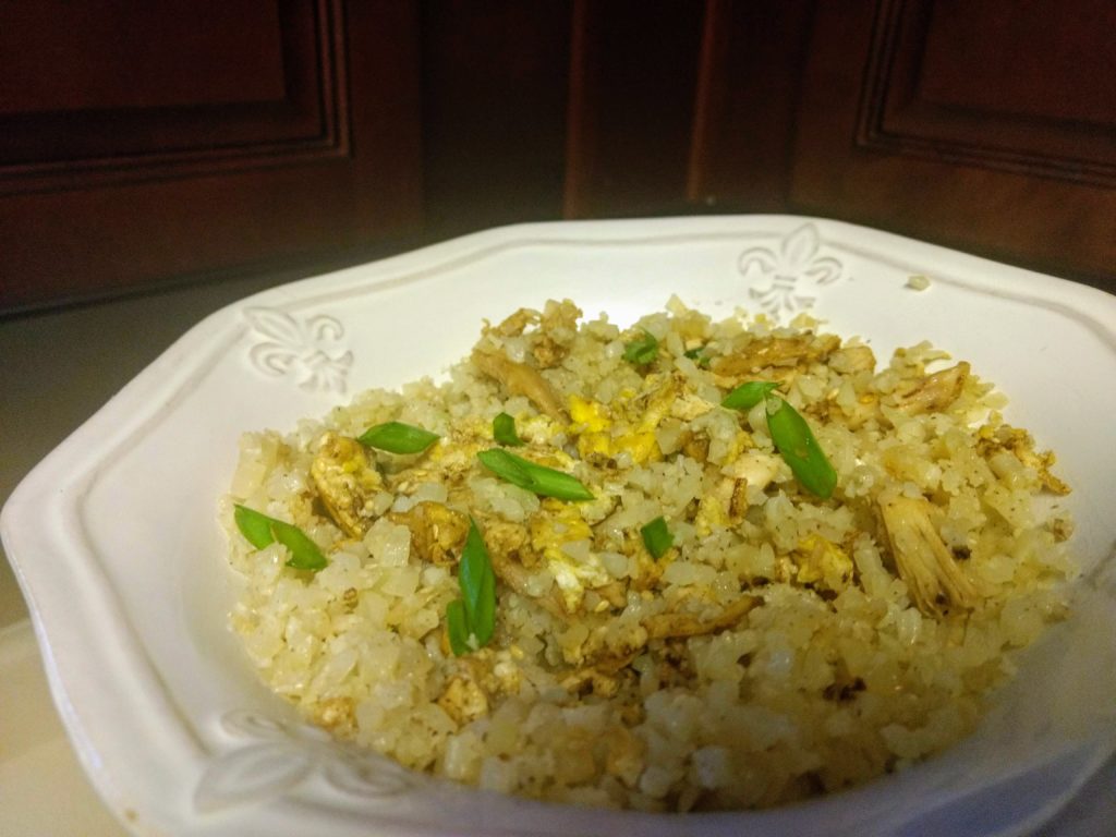 Chicken Fried Cauliflower rice, bowled up and topped with green onion.
